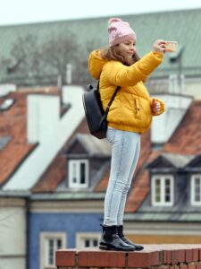 woman-in-yellow-puffer-jacket-and-blue-jeans-holding-3280807