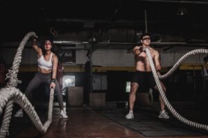 man-and-woman-holding-battle-ropes-1552242
