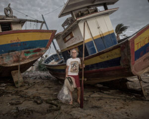 Gervasio Gonçalvez, crab catcher and fisherman at the Paraíba do Sul delta for the past 30 years, stands beside his boats, now stored at his house’s backyard. About 60% of the rivers water volume was detoured to supplies the city of Rio de Janeiro. The right mouth of the Paraíba do Sul delta is shutting and, due to silting, bigger boats cannot reach the high seas. The ones that get stranded in the attempt must wait until the full moon to continue their journey.